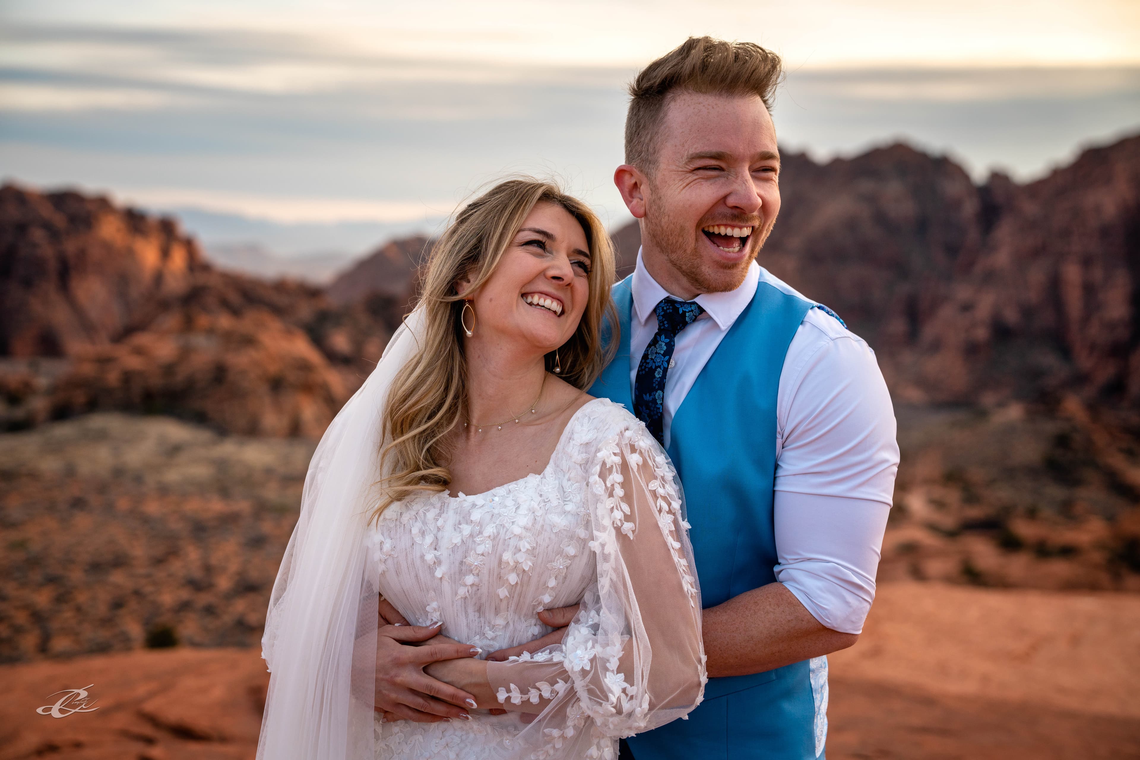Peter and his wife laughing together in the red rock mountains